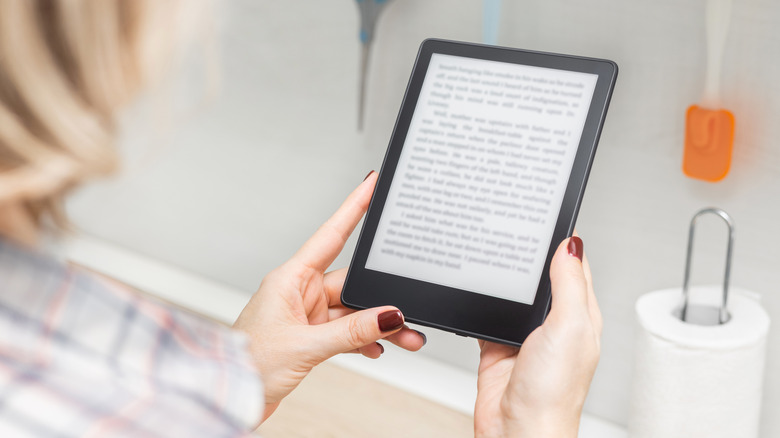 Someone holding a Kindle e-reader