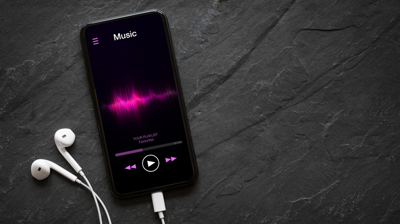 Music playing on a smartphone with earphones plugged in