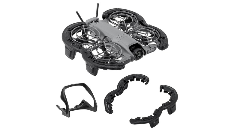 An image of a compact quadcopter drone fitted with protective propeller guards and accessory bumpers.