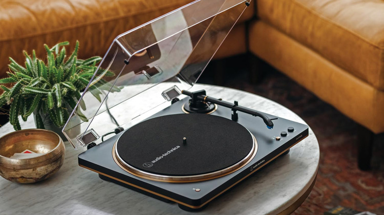 An Audio-Technica AT-LP70XBT on a coffee table.