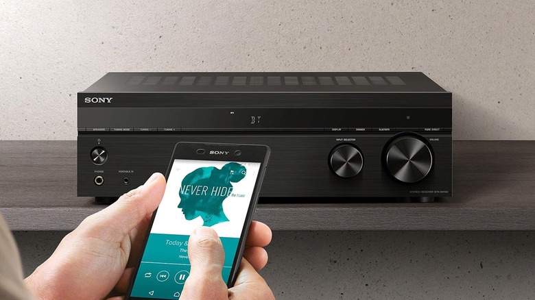 A Sony STRDH190 stereo receiver on a table with a smartphone in the foreground.