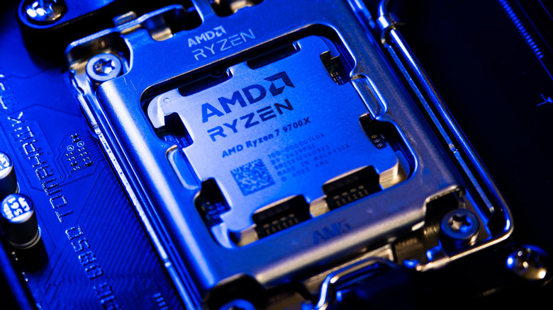 Close-up of an AMD Ryzen 7 9700X processor installed in an AM5 motherboard socket.