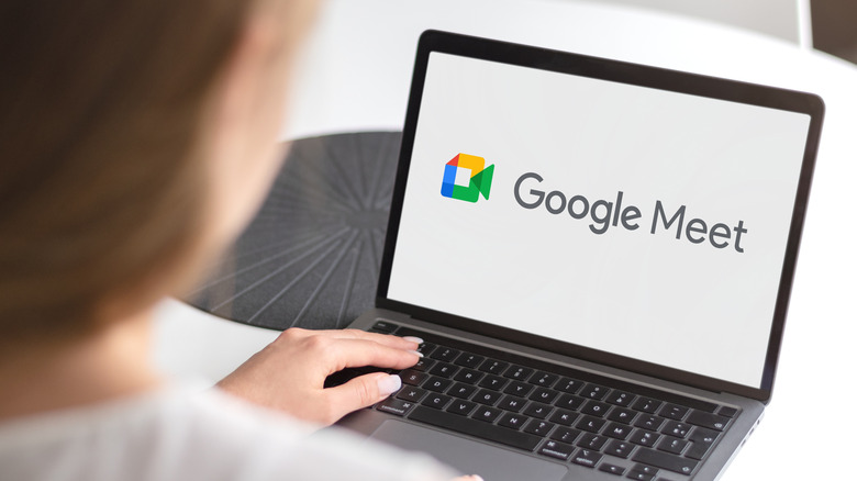 The Google Meet logo on the screen of a tablet with an attached keyboard.