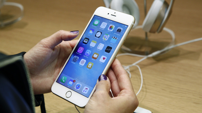 A customer checks the new iPhone 6s displayed at the Apple Store Opera