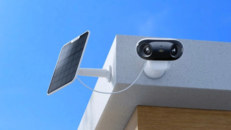 The Reolink Argus 4 Pro attached to a wall and connected to its solar panel.