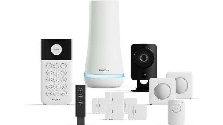 A product render of SimpliSafe's Smart Home Security Kit. The Kit includes a base station, a keypad, a camera, motion and door sensors, and a key fob.