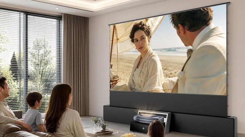 An AWOL Vision floor rising screen being used by a family to watch a film during daytime, paired with the AWOL Aetherion Max