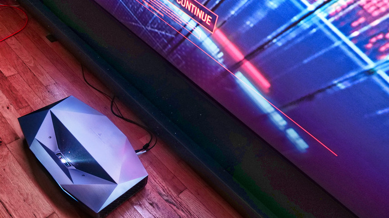 The AWOL Aetherion Max projecting a large image from a small throw distance directly in front of the screen