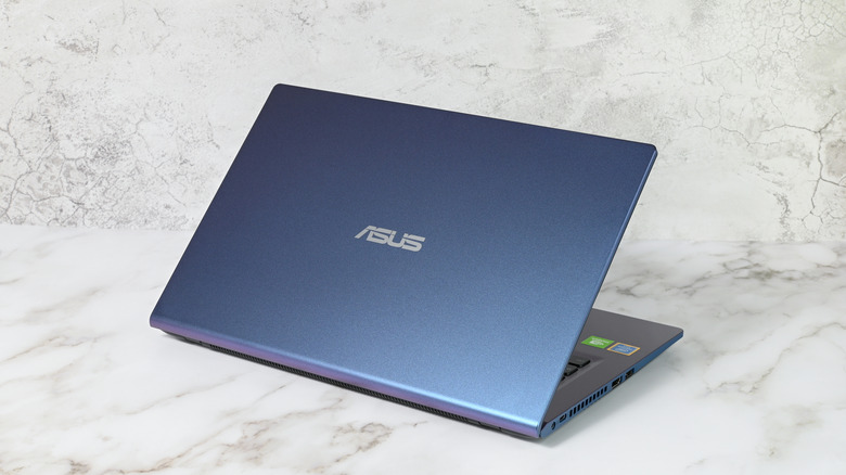 An ASUS Windows laptop on a marble surface.