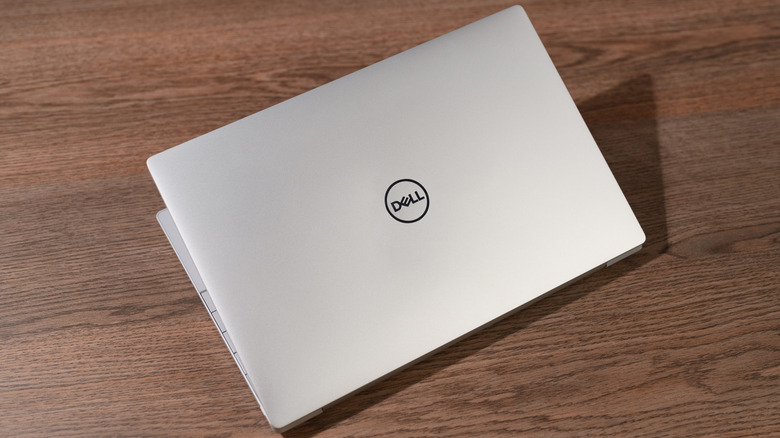 A Dell XPS laptop on a wooden surface.