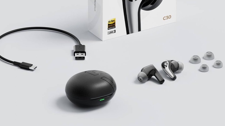 The Soundpeats C30 on a gray background, surrounded by other things you get in the box.