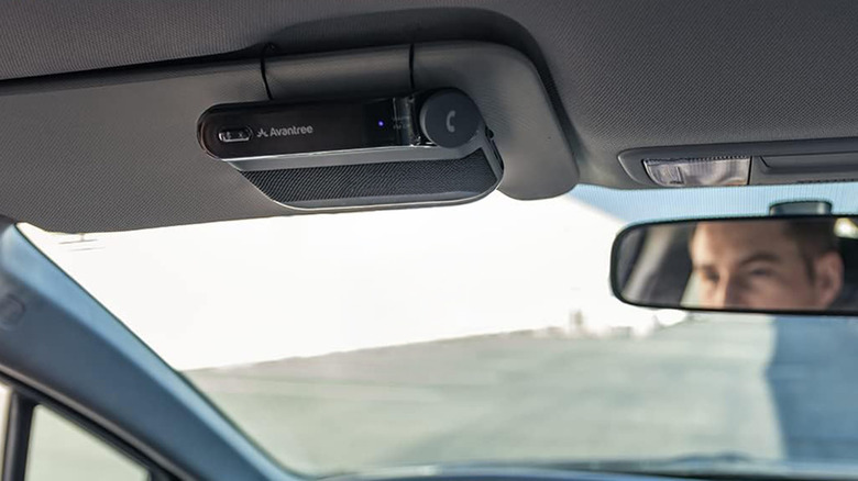 An Avantree Bluetooth car adapter attached to a car sun visor.