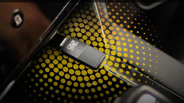 A Crux ACP-WLZ plugged into a car's USB port