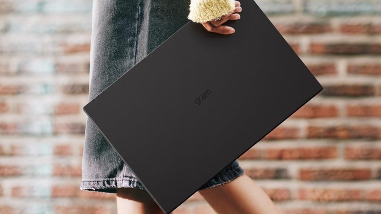 A person carrying the LG Gram Pro 17 laptop.
