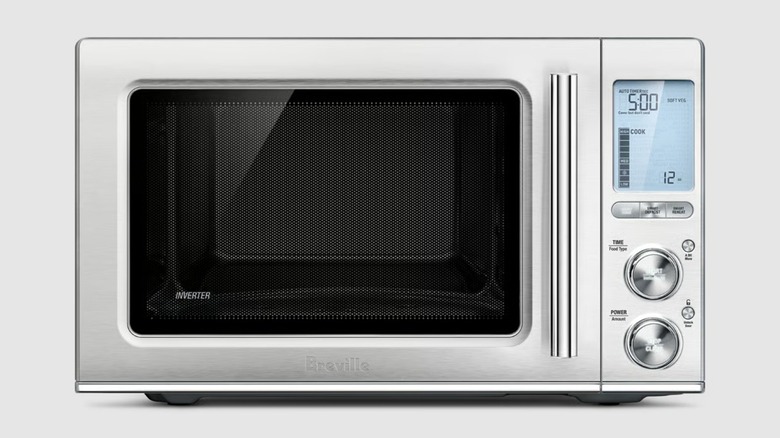 The Breville Smooth Wave BMO850BSS1BUC1 countertop microwave on a gray background.