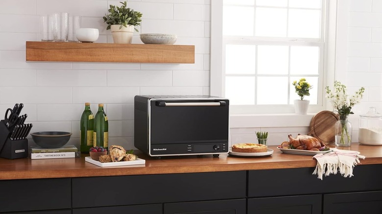 The KitchenAid KCO255BM toaster oven on a kitchen countertop.