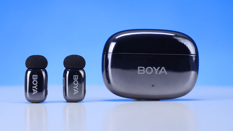 Four friends take a selfie on a rooftop at sunset, smiling and posing enthusiastically.