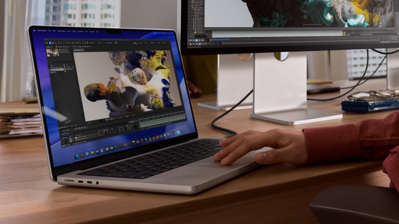 A person using M5 MacBook Pro at a desk