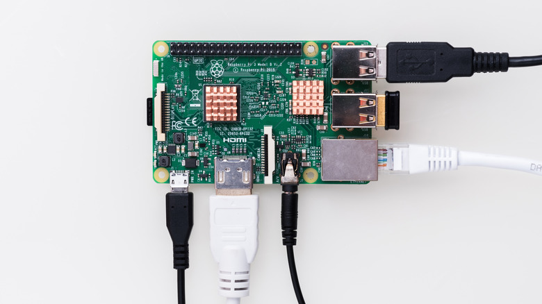 A bare Raspberry Pi board with several cables plugges in.