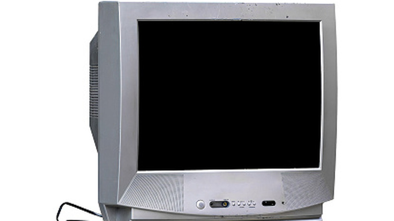 Front view of a gray CRT television with a blank screen and built-in speakers, isolated on a plain background.