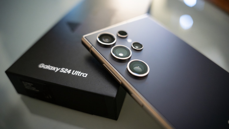 Close up of the Samsung Galaxy S24 Ultra resting atop its original packaging.