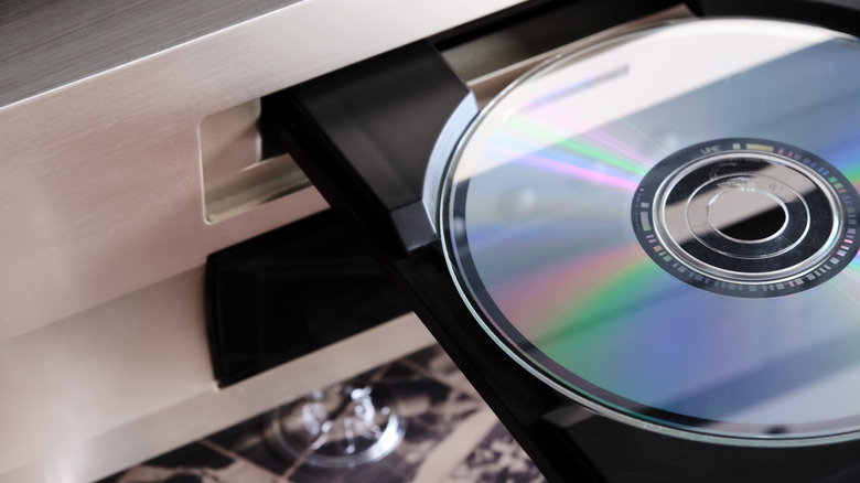 An optical disc partially inserted into a player.