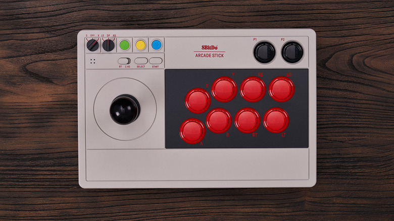The 8BitDo Arcade Stick on a wooden surface