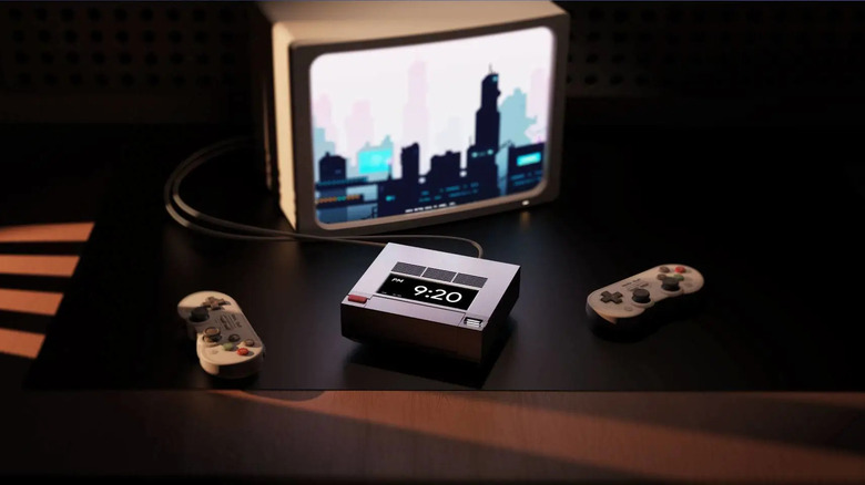 The Ayaneo Retro Mini PC AM02 hooked up to a CRT TV next to two game controllers