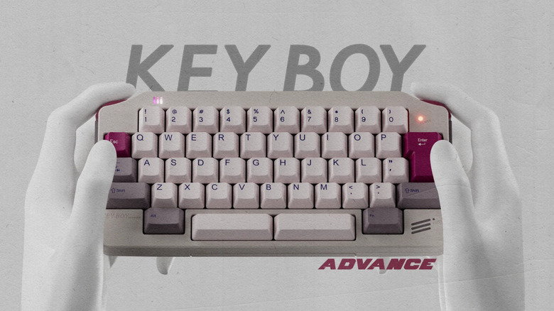 A pair of white hands holding the KeyBoy Advance keyboard