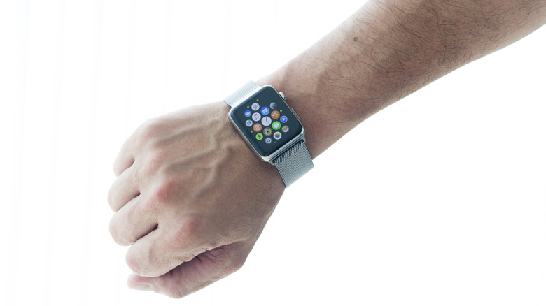 An Apple Watch with a metallic silver band worn on a person's arm.
