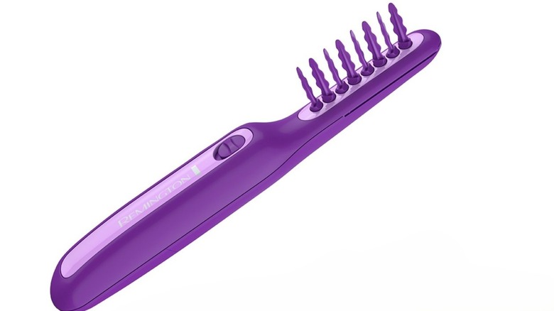 A large purple comb with twisted bristles and a large handle to store the batteries