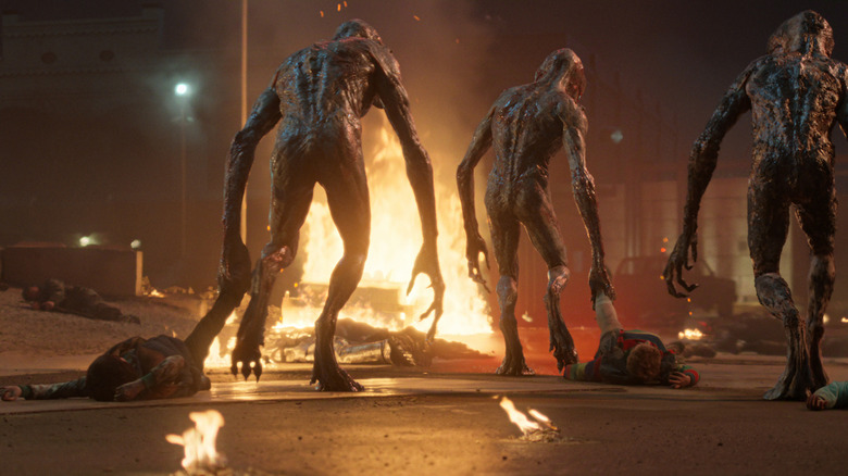 Demogorgons dragging people away with fire ahead in Stranger Things.