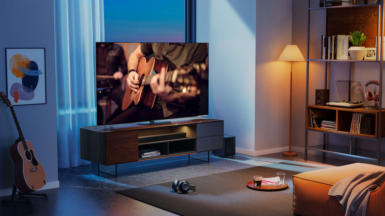 Hisense A85N sitting on a wooden TV table in a living room