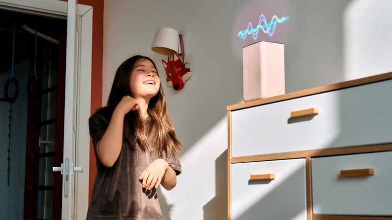 A young person talking to the Amazon Echo speaker with a visual depiction of the smart speaker talking back