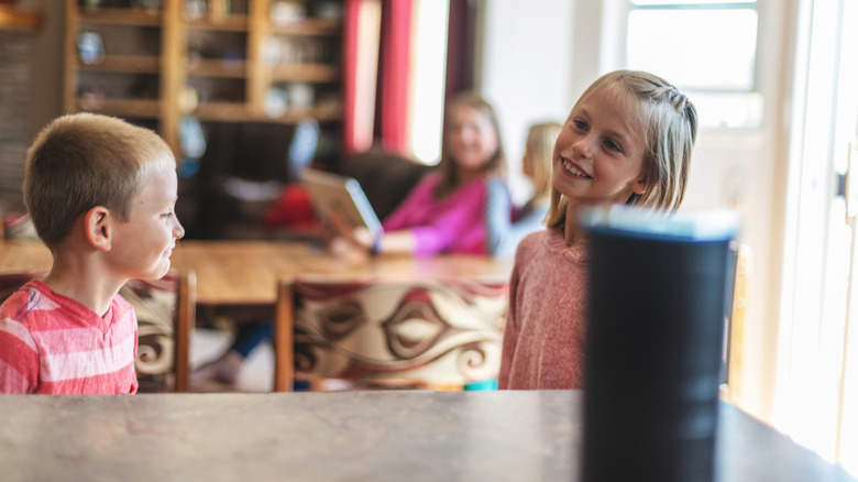 A family at home with an Amazon Echo speaker in the foreground