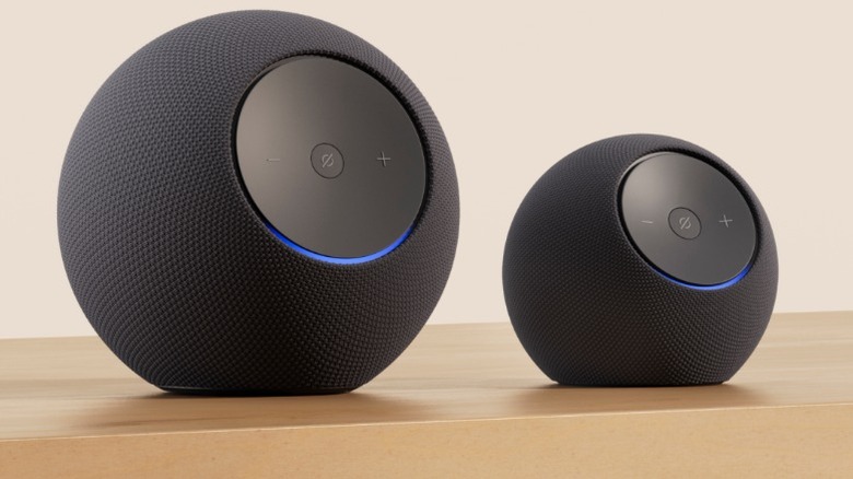 The Amazon Echo Dot Max sat next to the Amazon Echo Studio on the right on top of table.