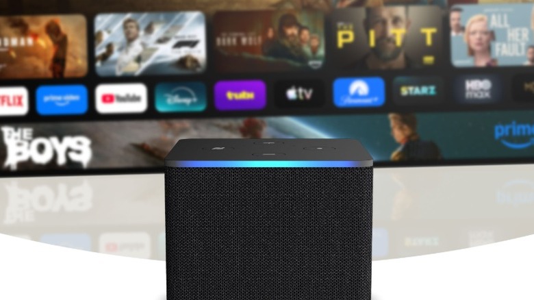 An Amazon Fire TV Cube sat in front of a TV.