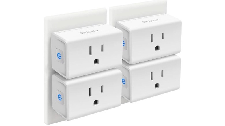Four Kasa Smart Plug Mini smart plugs connected top separate wall outlets.