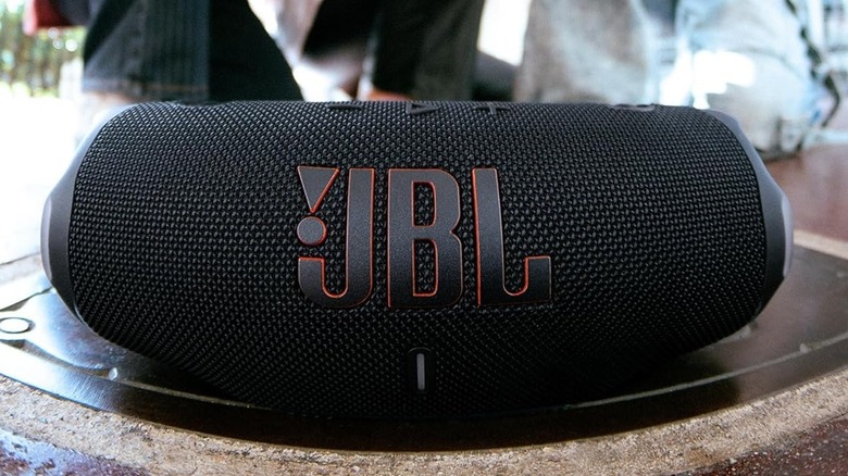 The JBL Charge 6 Bluetooth speaker outdoors, on the ground.
