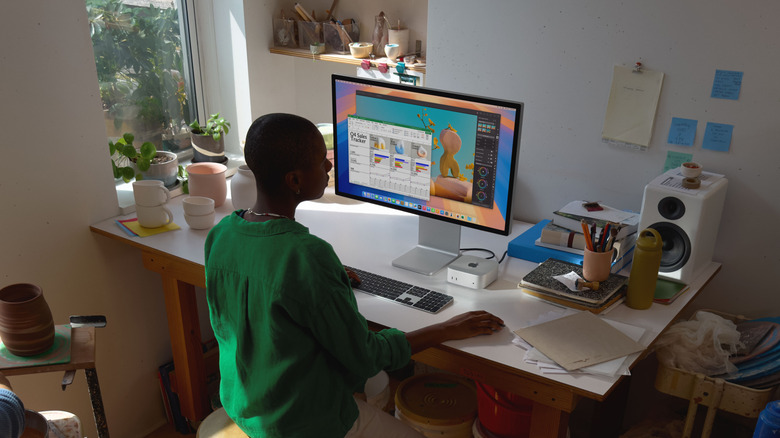 Mac mini desktop computer connected to a monitor on a work desk