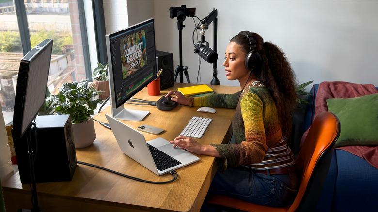 Woman using MacBook Pro connected to an external monitor