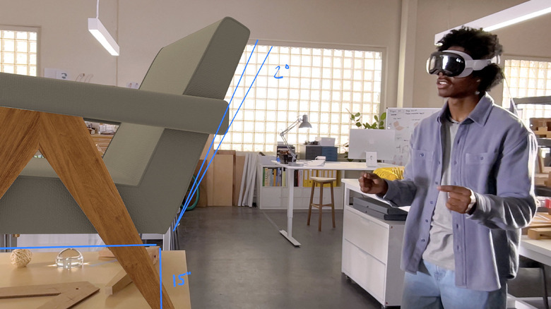 A man wearing Apple Vision Pro headset inside a modern workspace