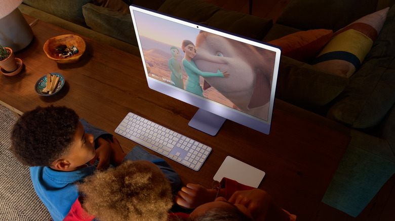 Kids watching an animated film on iMac