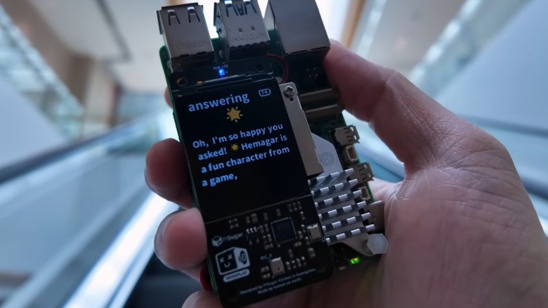 An image of an AI assistant running on a Raspberry Pi. The Raspberry Pi features a color display showing a response from an AI model.