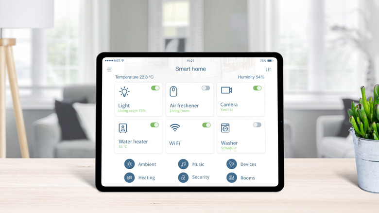 A render of a tablet resting on a wooden table displaying a smart home control panel