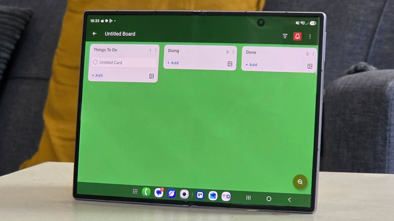 A Samsung Galaxy Z Fold 8 showing an empty Trello board with a green background.