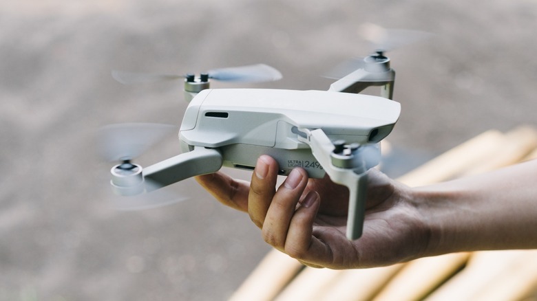 A hand holding an ultralight drone