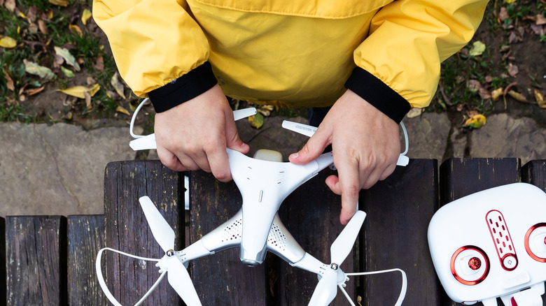 A child holding a white drone