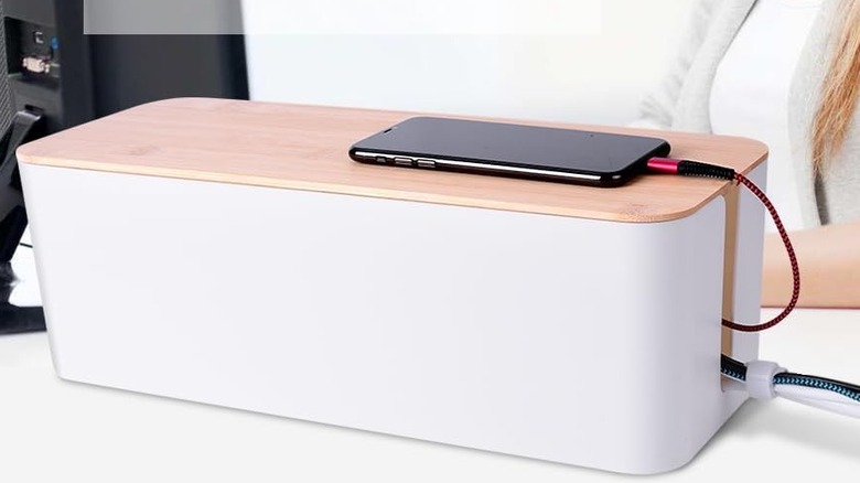 The Chouky Cable Organizer Box with cables running out of it.