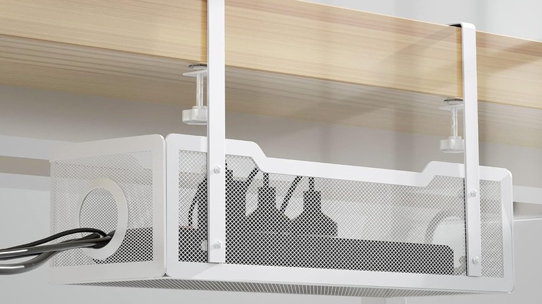 The Cinati Under Desk Cable Management Tray installed, with a power strip and cables inside.